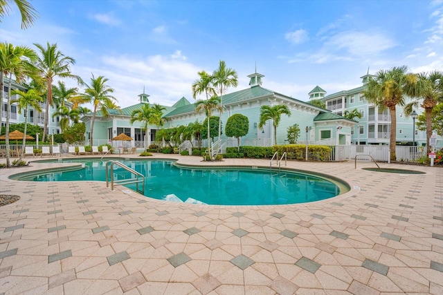 community pool featuring a patio area and fence