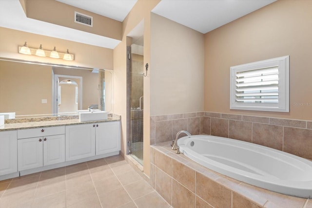 full bathroom with tile patterned flooring, a garden tub, vanity, visible vents, and a shower stall