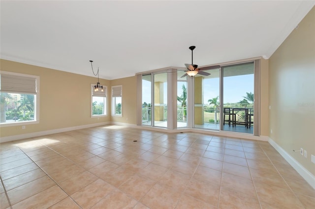 tiled empty room with ceiling fan and crown molding