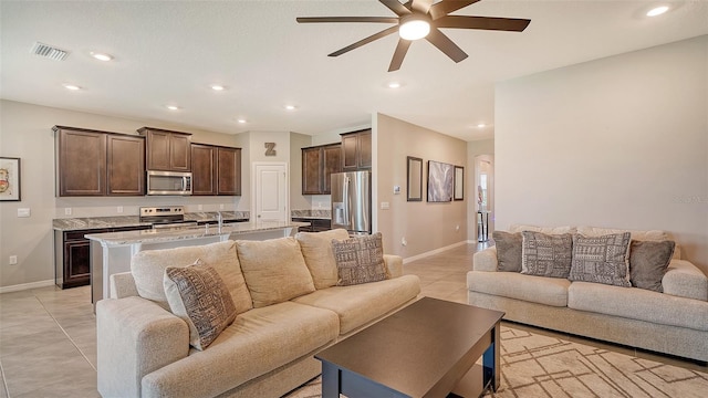 living room featuring ceiling fan and light tile patterned flooring