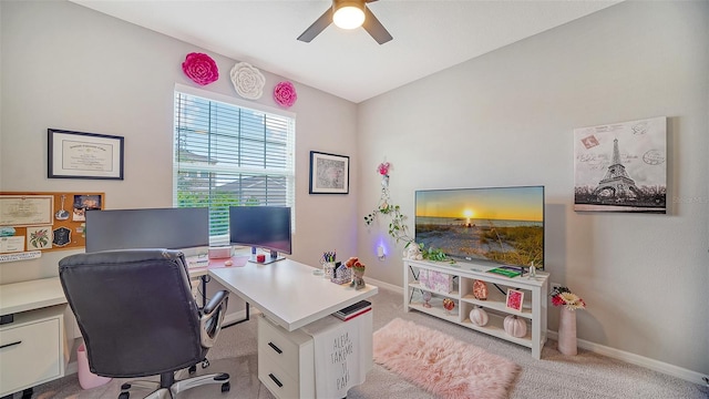 home office featuring light carpet and ceiling fan