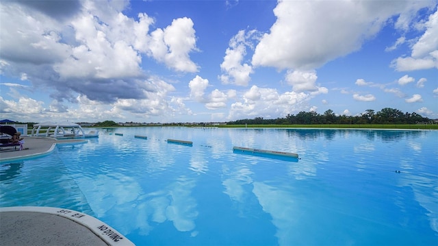 view of pool with a water view