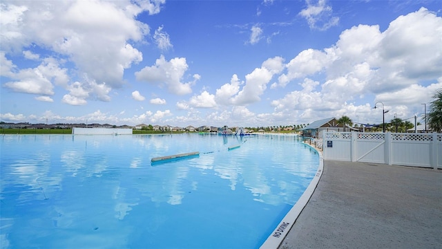 view of pool featuring a water view