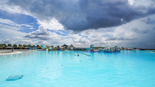 view of pool with a water view