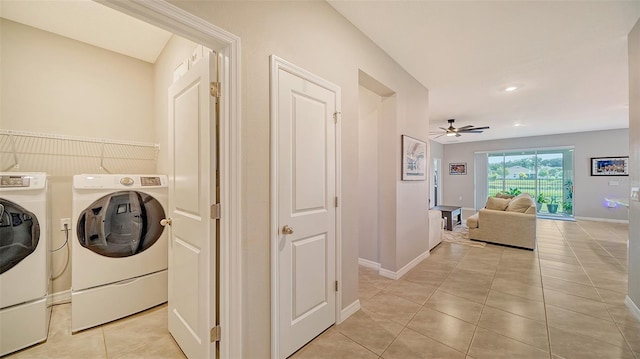 clothes washing area featuring ceiling fan, light tile patterned flooring, and washing machine and clothes dryer