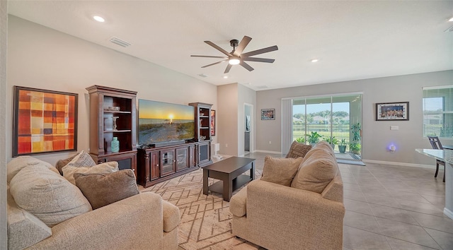 living room with ceiling fan, light tile patterned floors, and a wealth of natural light