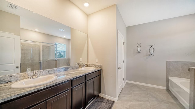 bathroom featuring tile patterned floors, vanity, and plus walk in shower