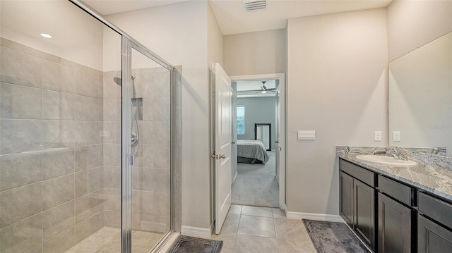 bathroom featuring tile patterned floors, ceiling fan, walk in shower, and vanity