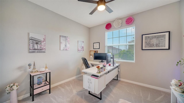 carpeted home office with ceiling fan and vaulted ceiling