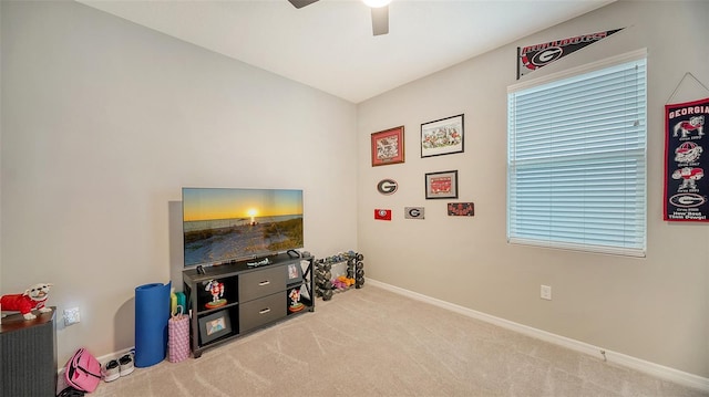 recreation room featuring light carpet and ceiling fan