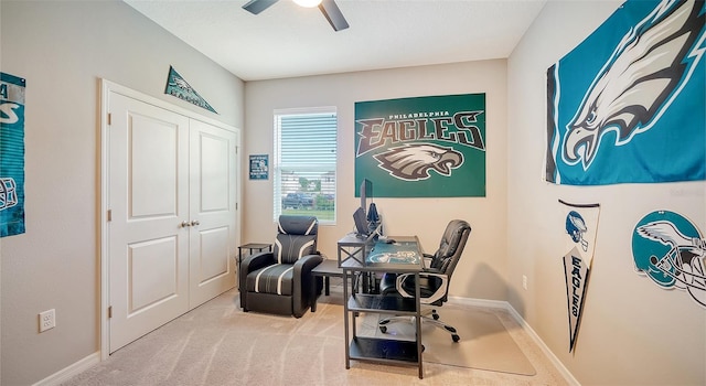 carpeted office space with ceiling fan