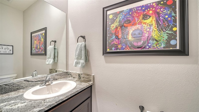 bathroom with vanity and toilet