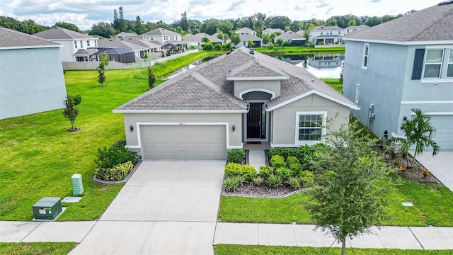 view of front of property featuring a front lawn, a water view, and a garage