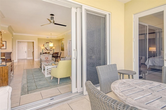 exterior space featuring ceiling fan with notable chandelier and crown molding