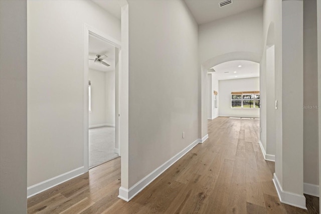 corridor with light hardwood / wood-style floors