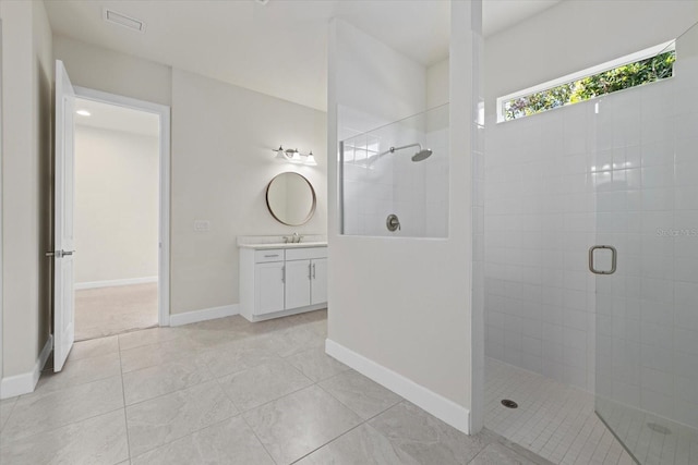 bathroom featuring tile patterned floors, an enclosed shower, and vanity