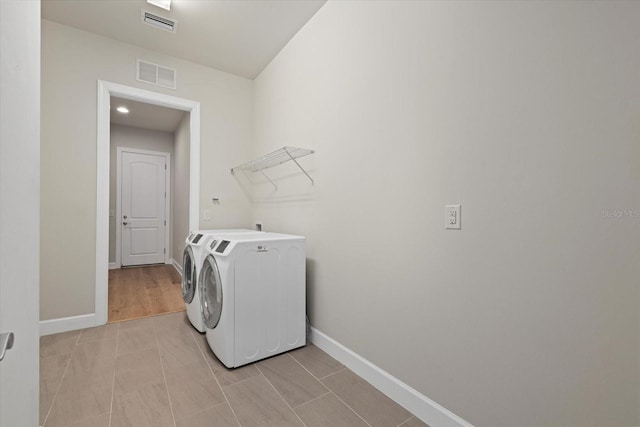 clothes washing area featuring separate washer and dryer