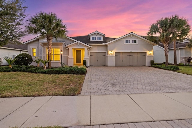 view of front of home featuring a lawn and a garage