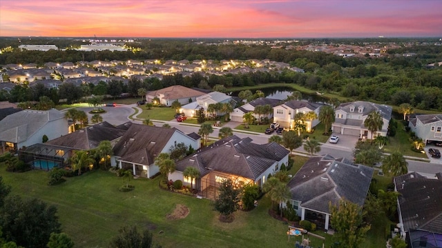 aerial view at dusk with a water view