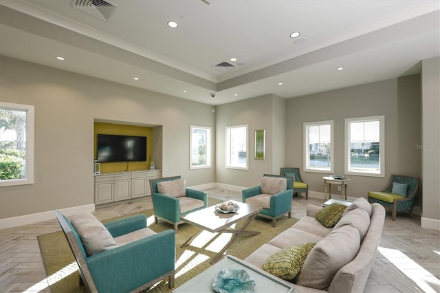 living room with ornamental molding and light parquet flooring