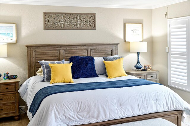 bedroom featuring wood-type flooring and ornamental molding