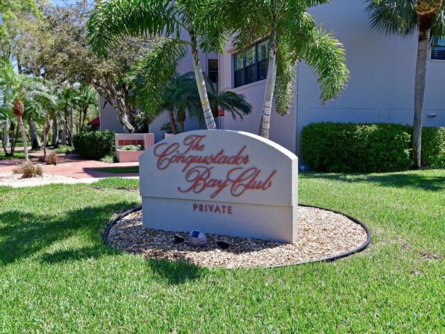 community sign featuring a yard