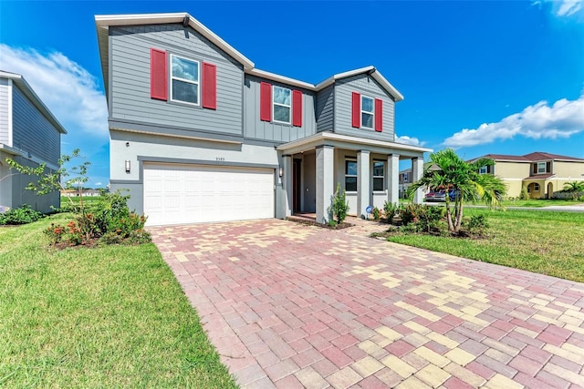 view of front of home with a garage and a front lawn