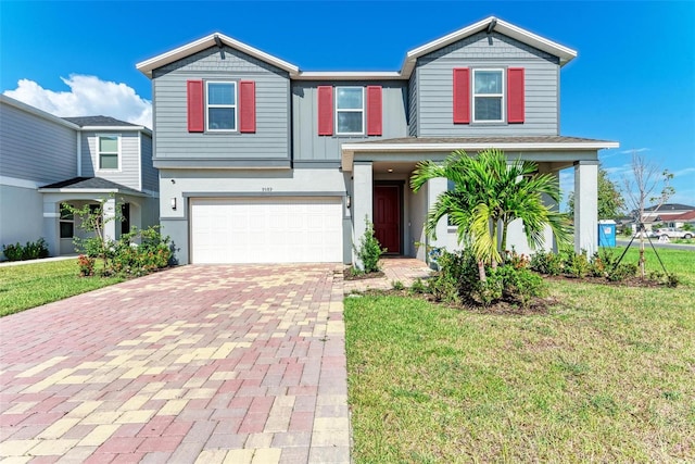 view of front of house featuring a garage and a front lawn