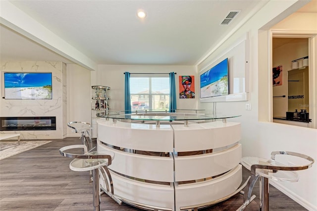 interior space with a high end fireplace and hardwood / wood-style flooring