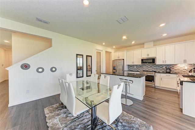 interior space featuring a textured ceiling, sink, and dark hardwood / wood-style flooring