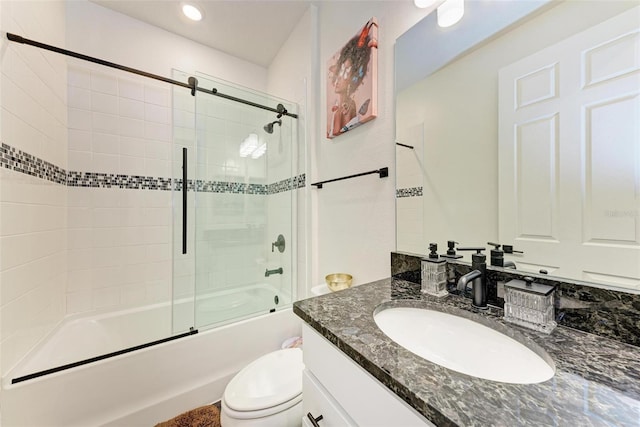 full bathroom with shower / bath combination with glass door, vanity, and toilet