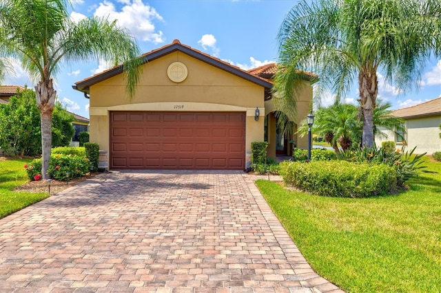 view of front of property featuring a garage and a front lawn