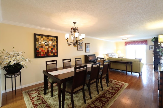 dining area with a textured ceiling, crown molding, and dark hardwood / wood-style floors