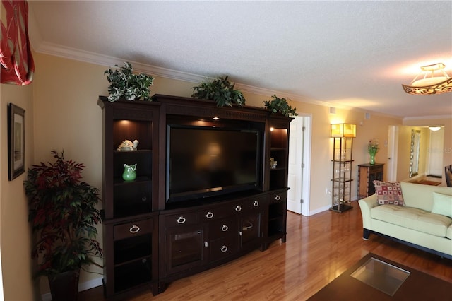 living room featuring ornamental molding, a textured ceiling, and hardwood / wood-style flooring