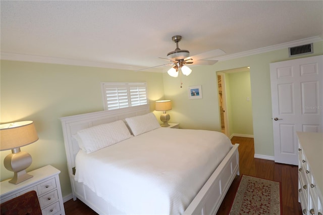 bedroom with ceiling fan, dark wood-type flooring, and crown molding