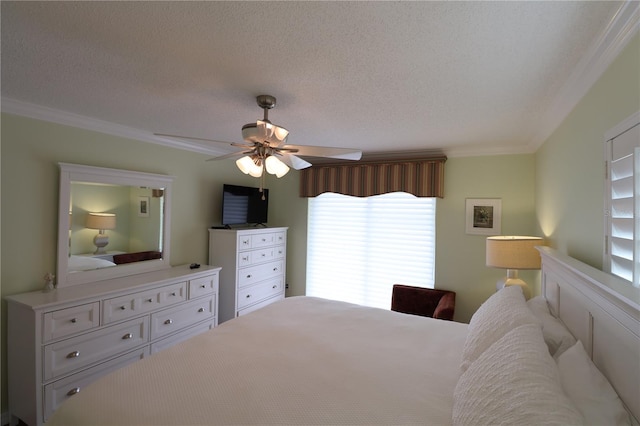 bedroom with a textured ceiling, ornamental molding, and ceiling fan