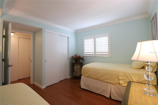 bedroom featuring crown molding and dark hardwood / wood-style floors