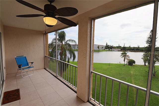 unfurnished sunroom with a healthy amount of sunlight, a water view, and ceiling fan