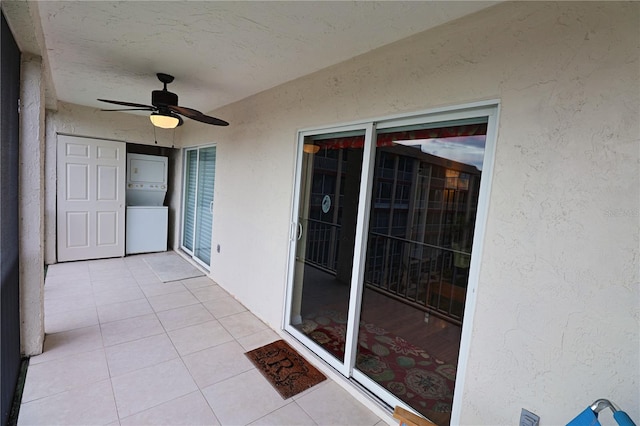 exterior space featuring stacked washing maching and dryer and ceiling fan