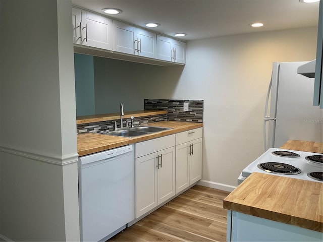 kitchen with white appliances, wood counters, and white cabinets