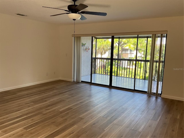 empty room with ceiling fan and hardwood / wood-style flooring