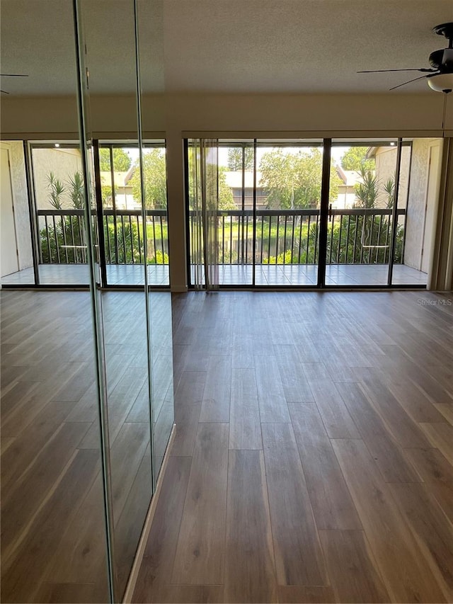 interior space with ceiling fan and wood finished floors