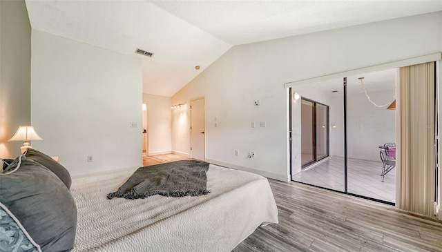 bedroom with hardwood / wood-style flooring and lofted ceiling