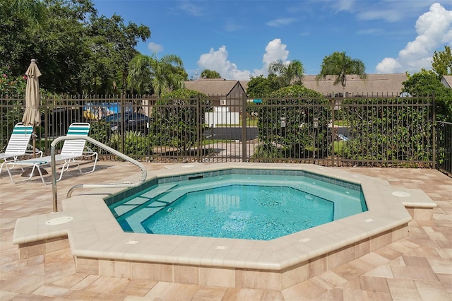 view of pool featuring a community hot tub and a patio