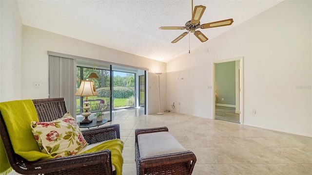 sitting room featuring light tile patterned floors, a textured ceiling, high vaulted ceiling, and ceiling fan