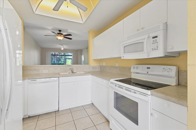 kitchen with ceiling fan, white cabinets, light tile patterned floors, sink, and white appliances