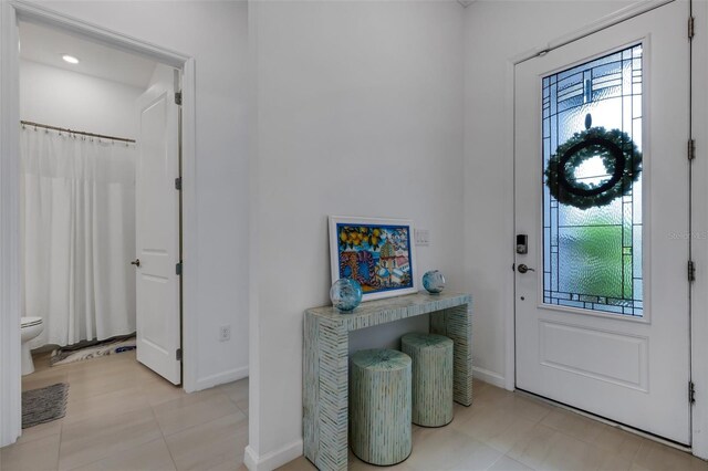 foyer featuring light tile patterned floors