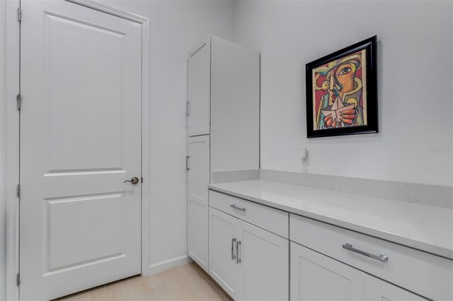 interior space with white cabinets and light hardwood / wood-style floors