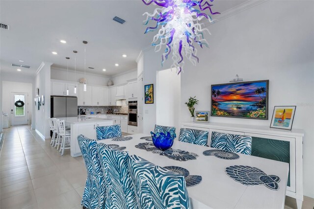 living room with light tile patterned floors, sink, and ornamental molding