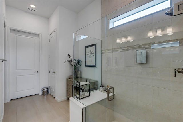 bathroom with vanity, a shower with door, and tile patterned floors